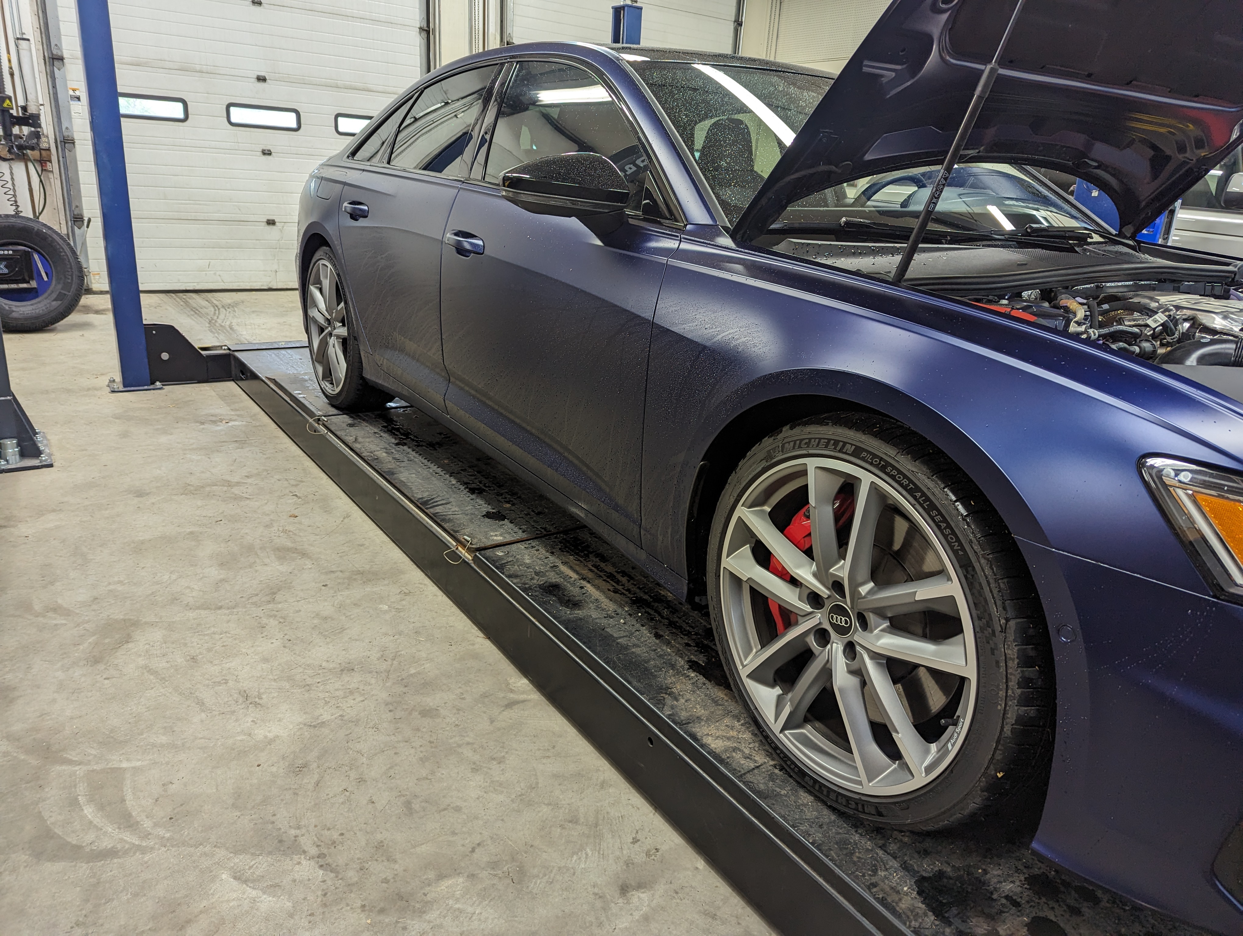 Audi S6 on alignment rack at Lux AutoHause with red brake calipers