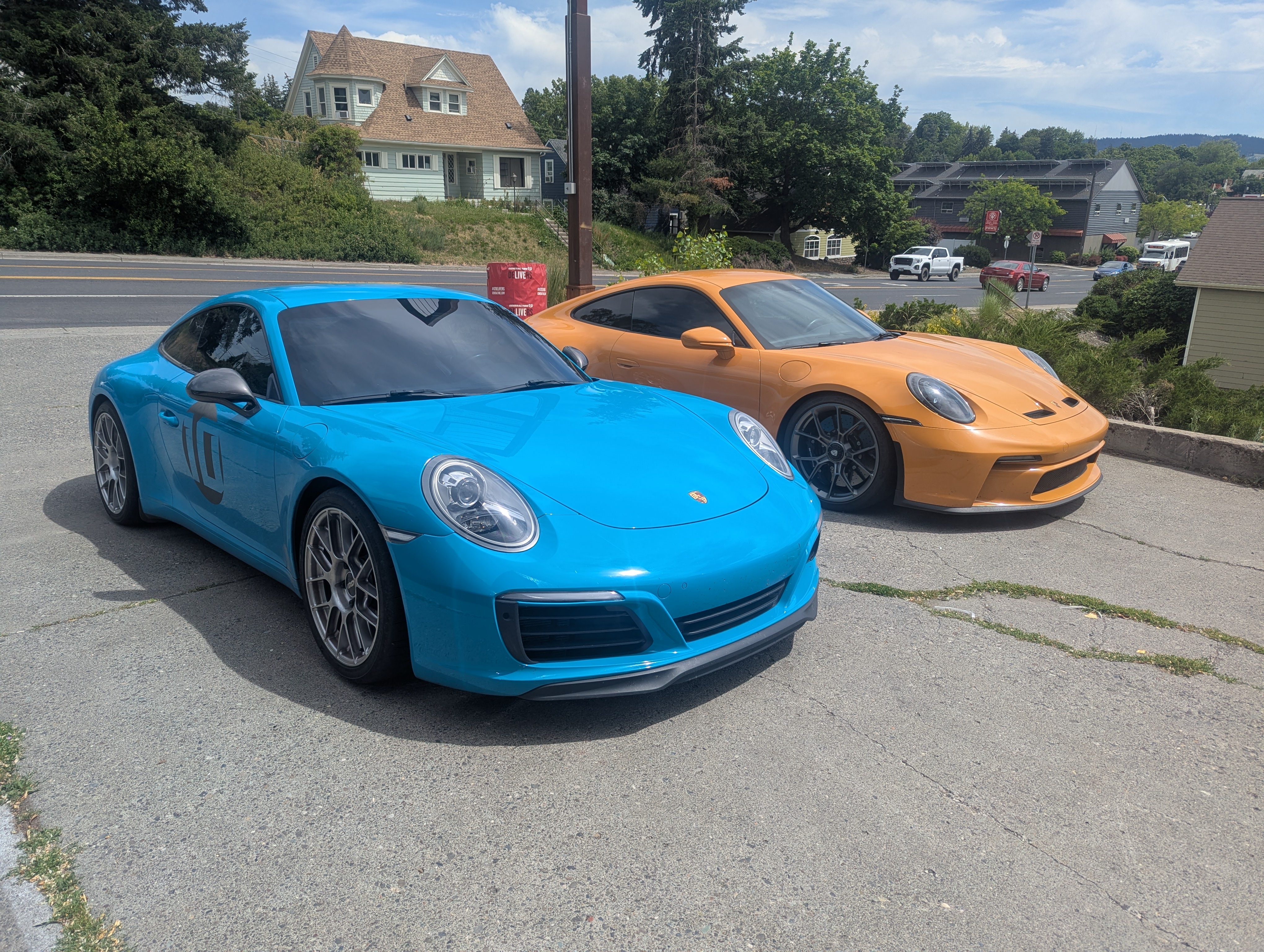 Two Porsche 911s — Miami Blue and Orange GT3 — serviced at Lux AutoHause in Moscow Idaho